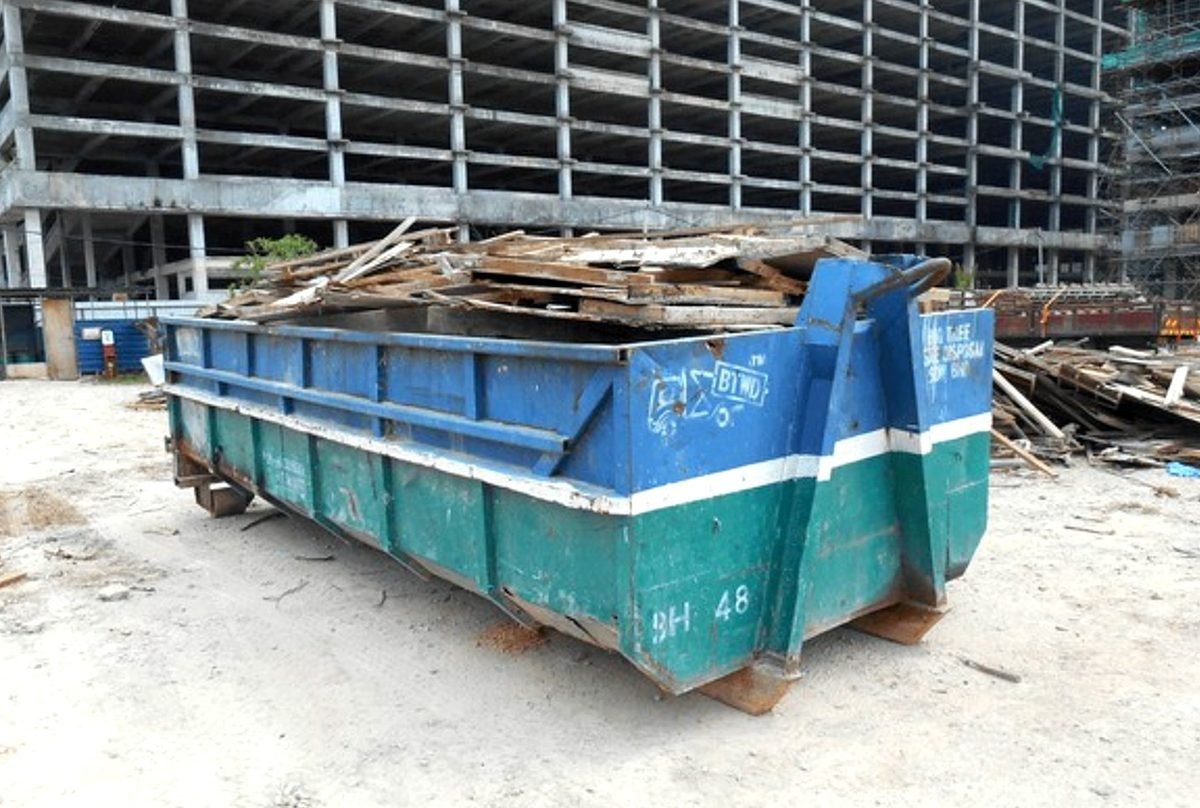 Iron Ridge Dumpster Works roll-off container delivery on residential driveway in Birmingham